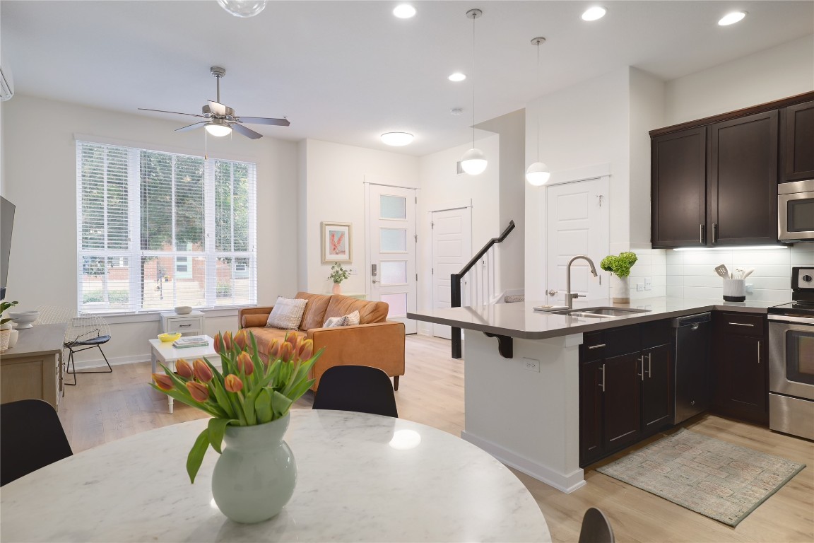 a living room with furniture potted plant a sink and a window