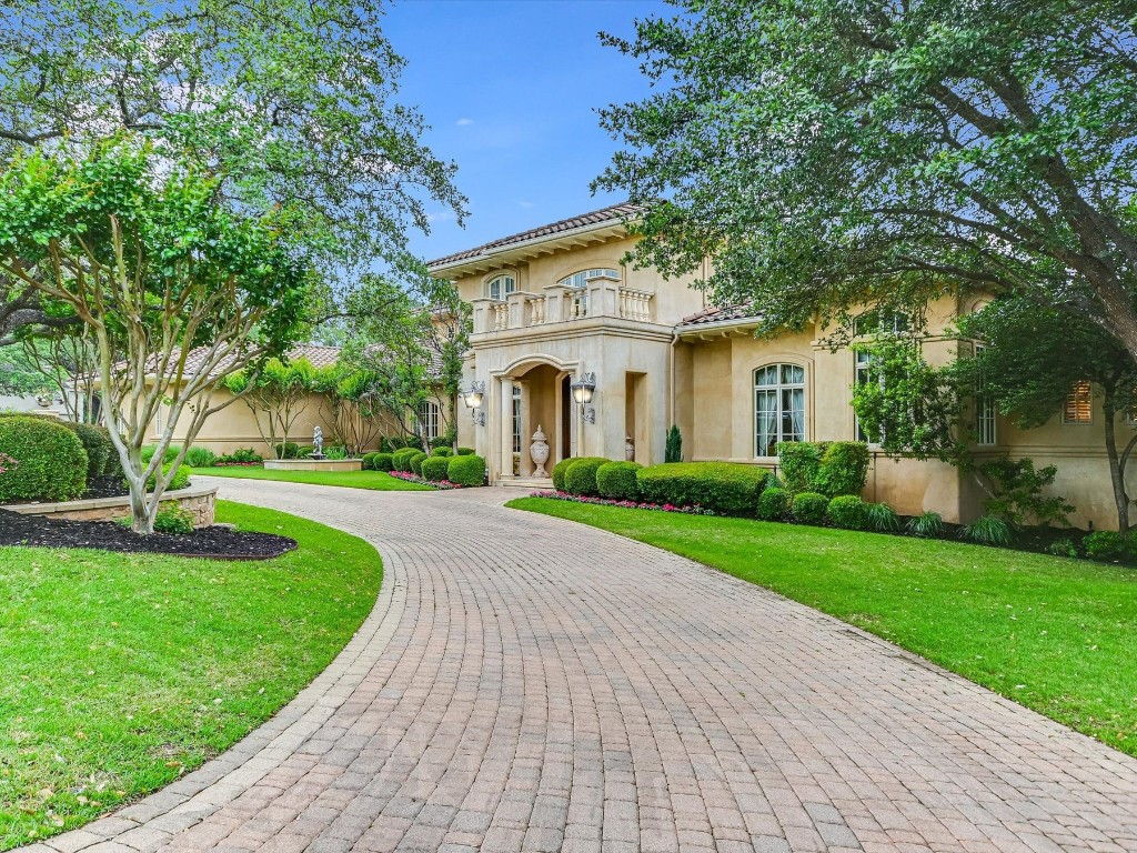 a view of a white house with a yard