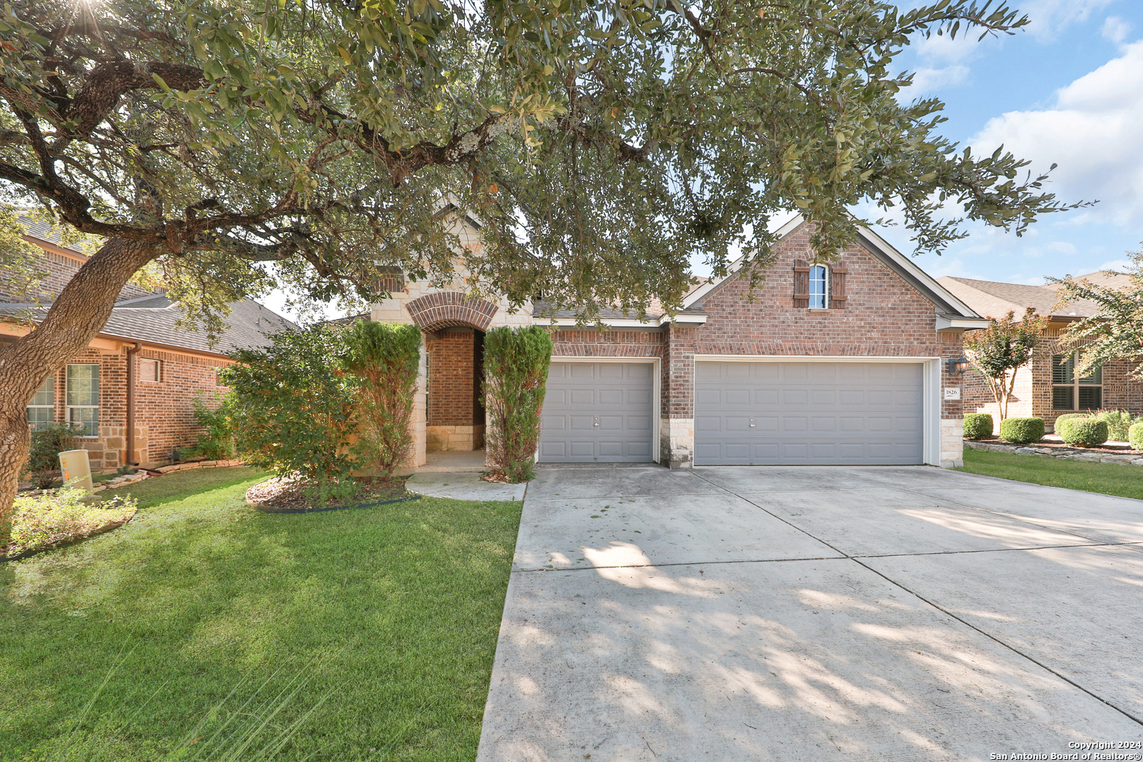 a front view of a house with a yard and garage