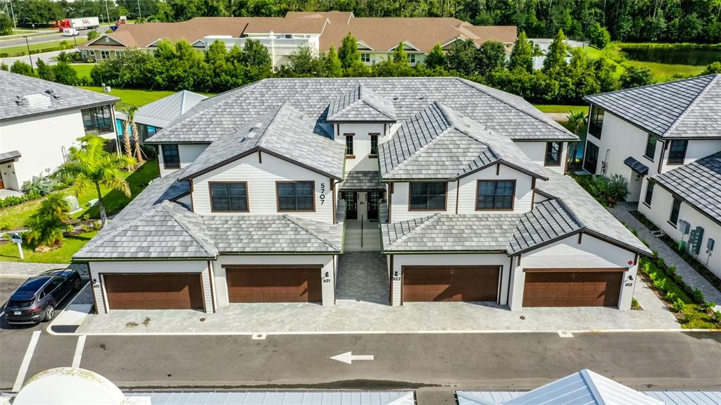 a aerial view of a house with a yard and potted plants