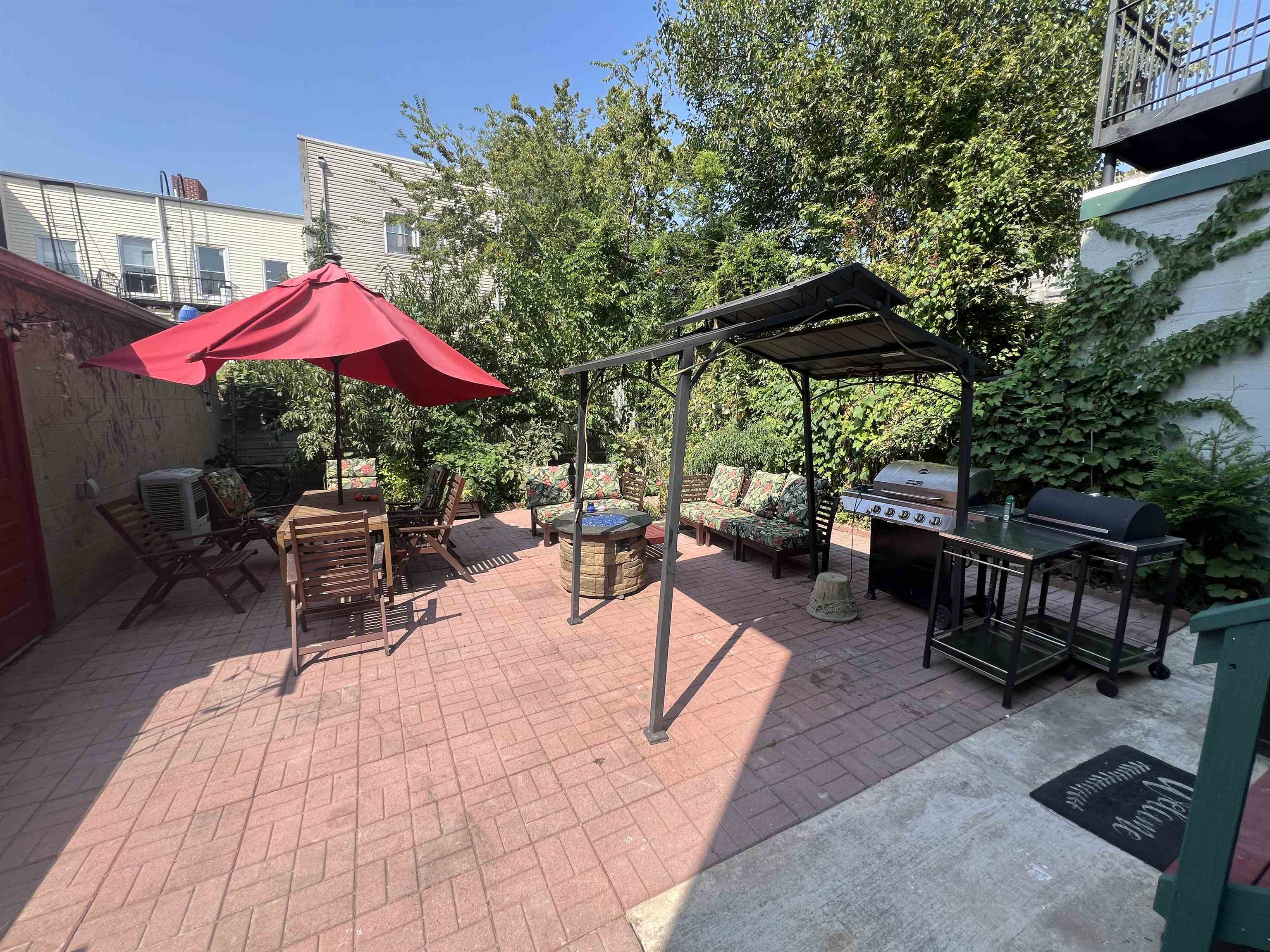 an outdoor space with patio lots of furniture and umbrella