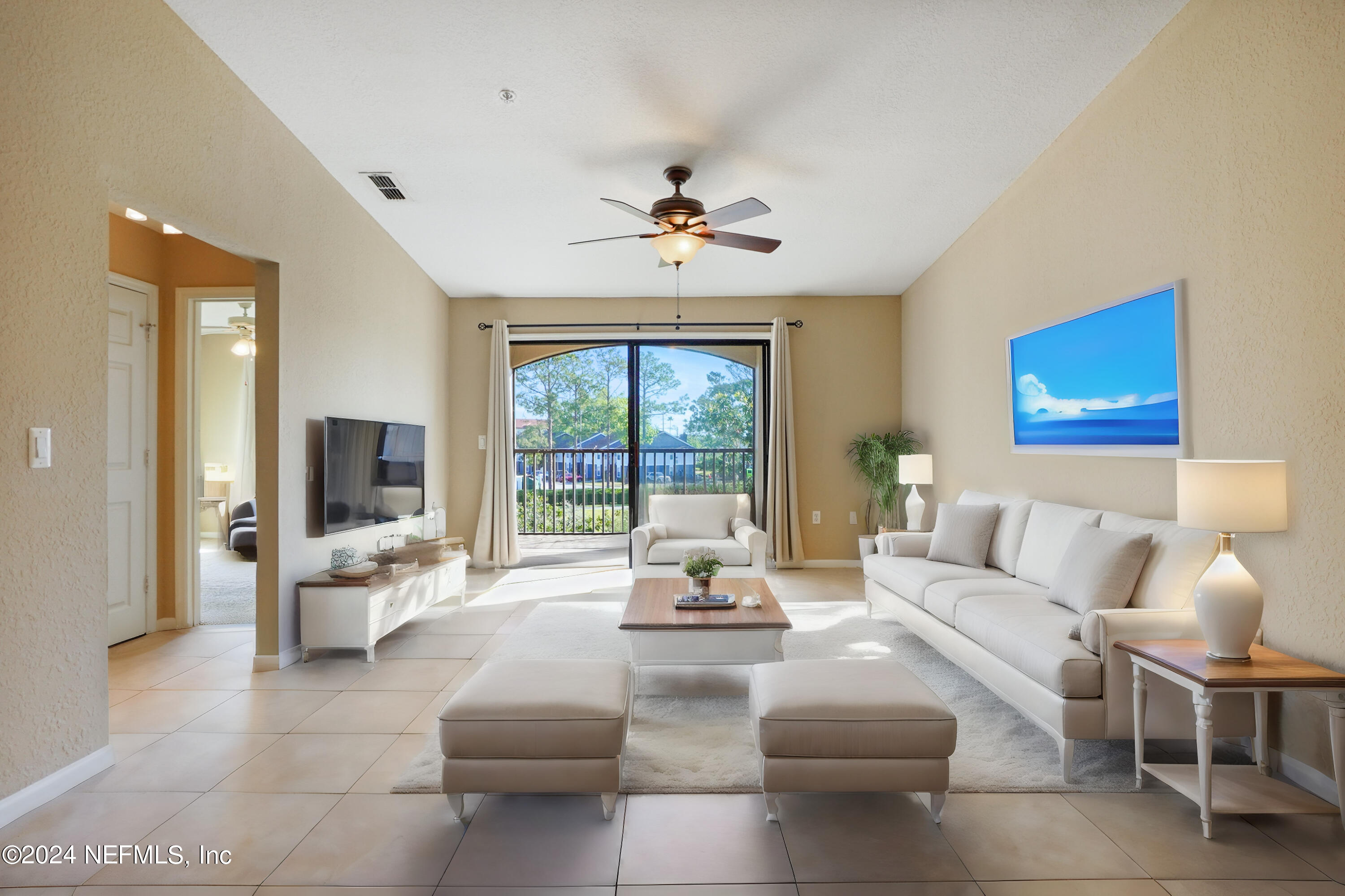 a living room with furniture and large windows