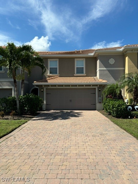 a front view of a house with a yard and garage