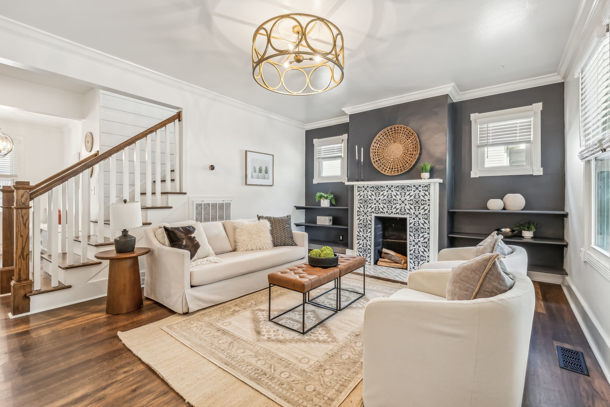 a living room with furniture a fireplace and a large window