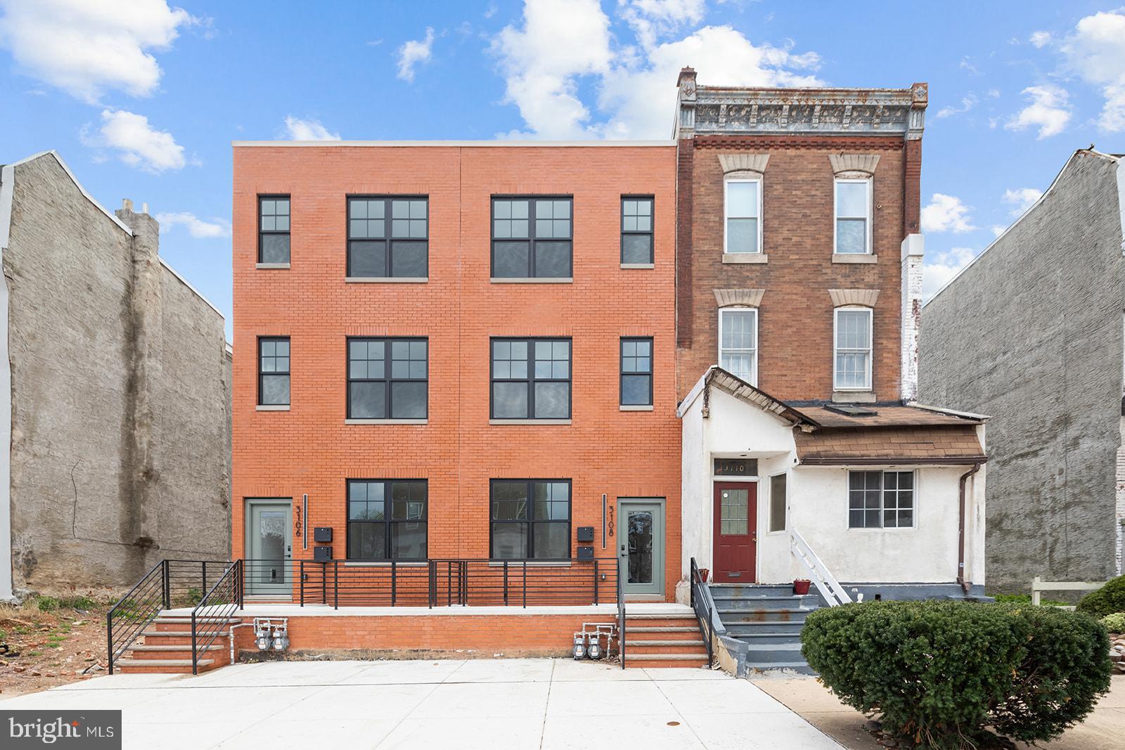 a front view of a residential apartment building with a yard