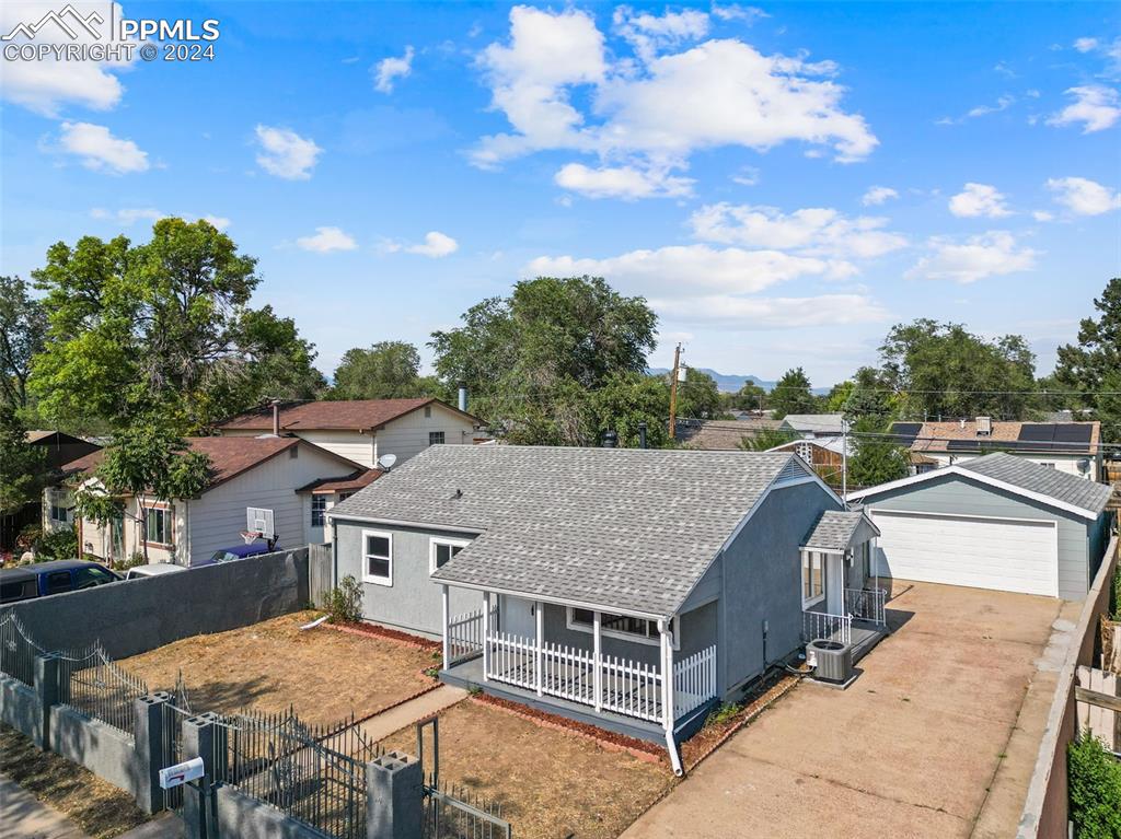 an aerial view of a house with yard porch and sitting area