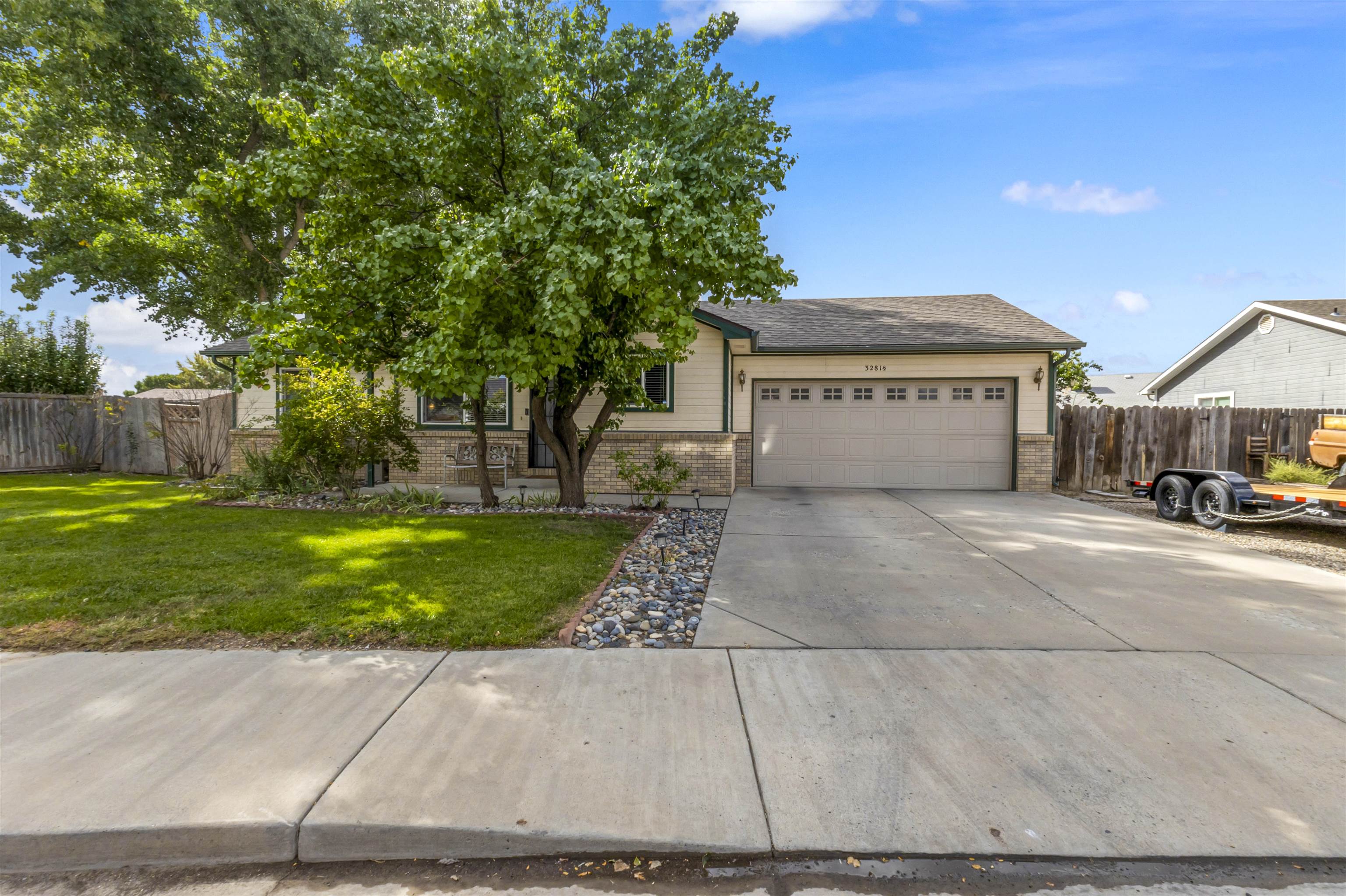 a front view of a house with a yard and a garage