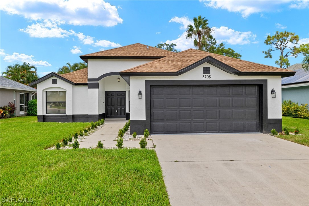 a front view of a house with a yard and garage