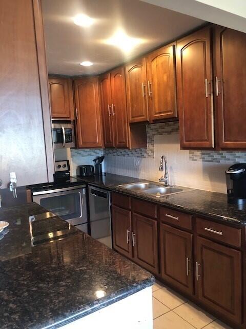 a kitchen with wooden cabinets and a sink