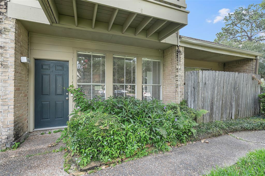 a view of a house with potted plants and a window