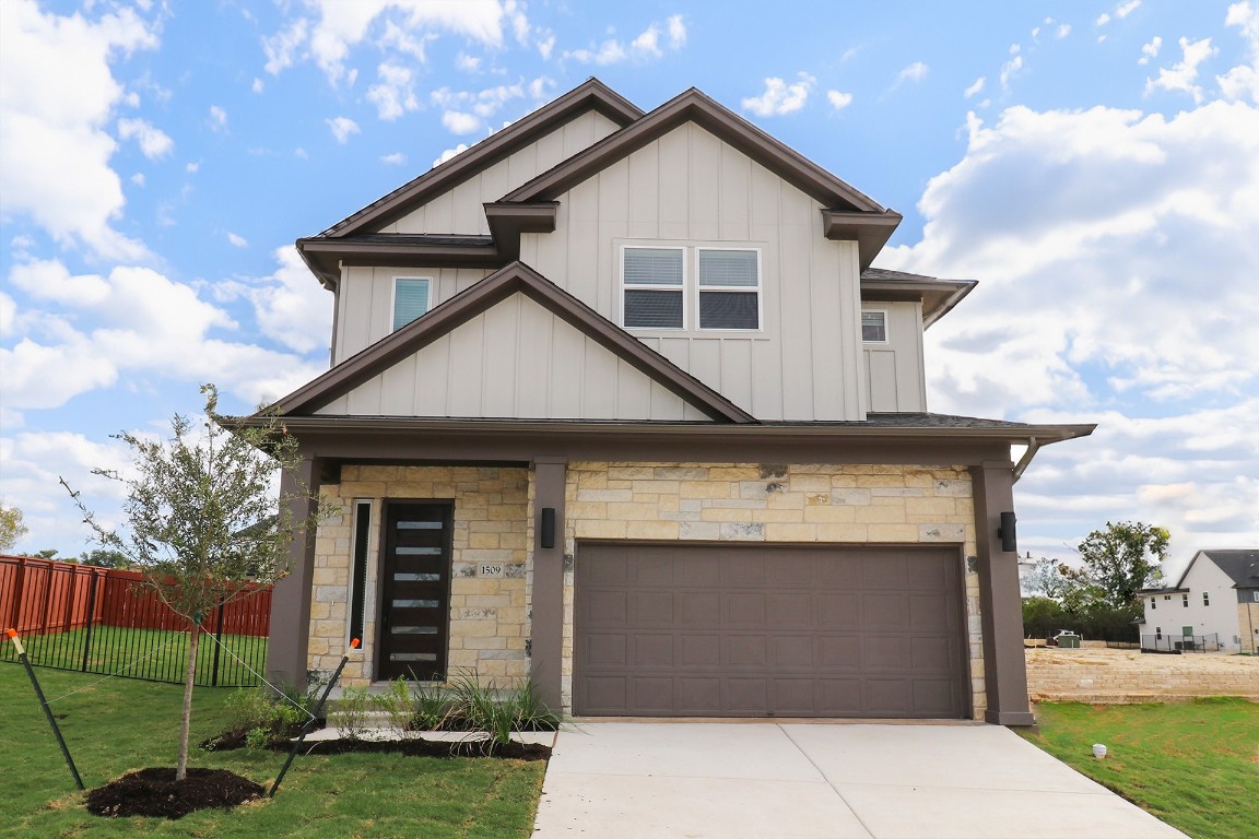 a front view of a house with a yard and garage