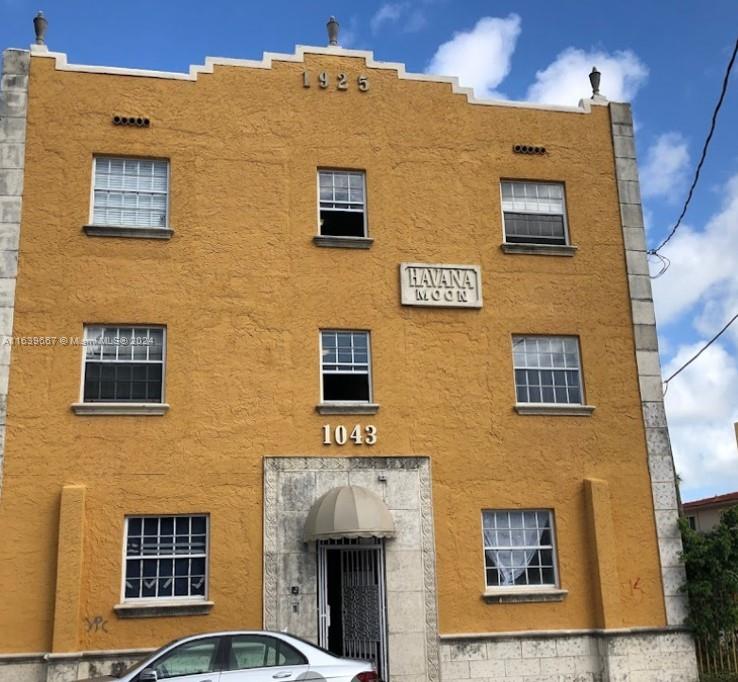 a front view of a building with many windows