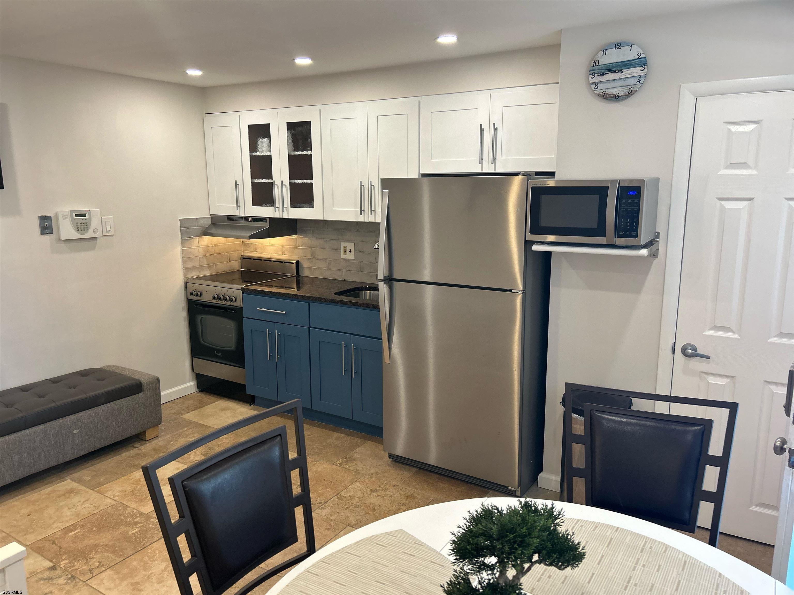 a kitchen with a refrigerator and a microwave