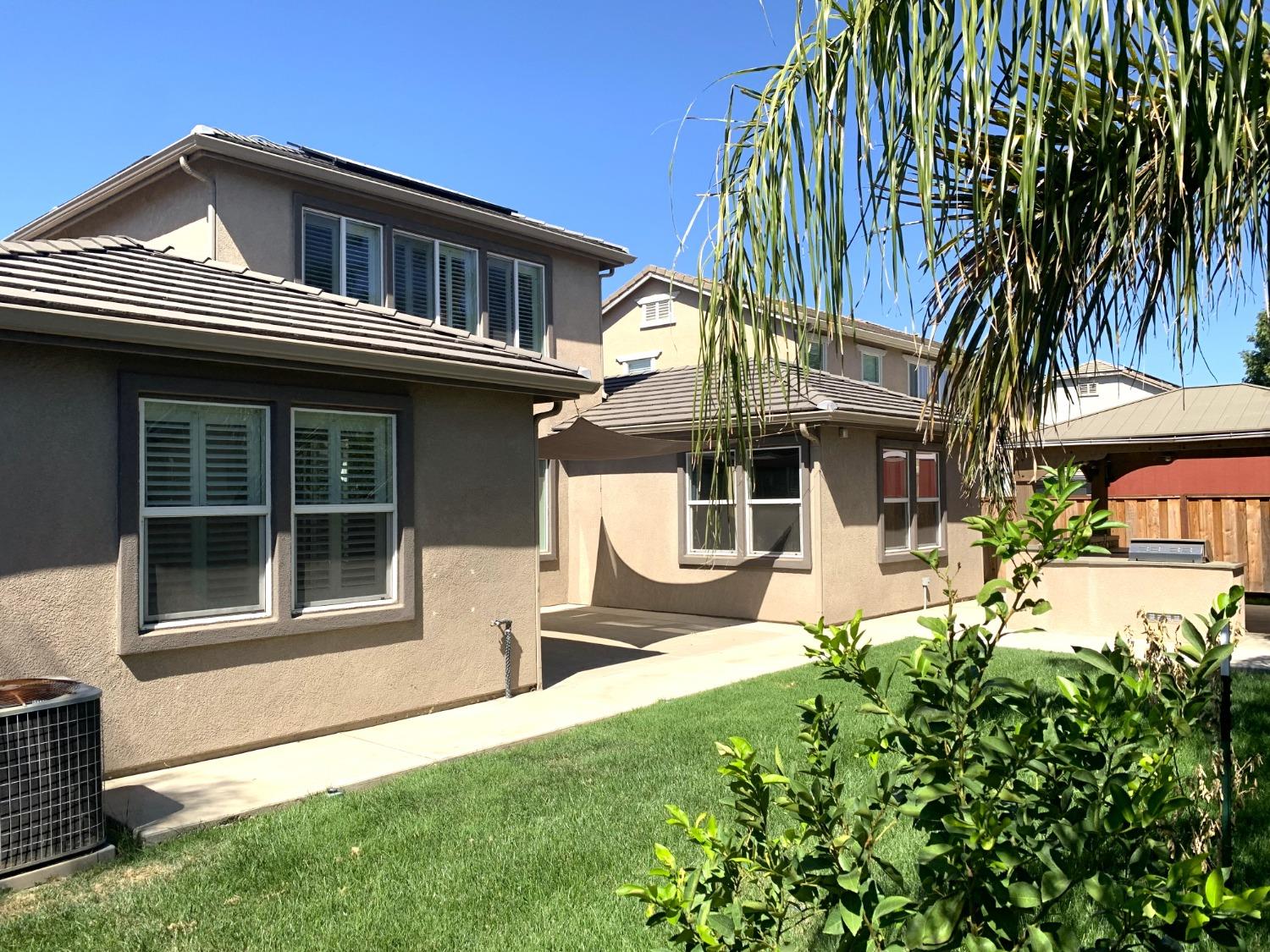 a view of a house with a yard and sitting area