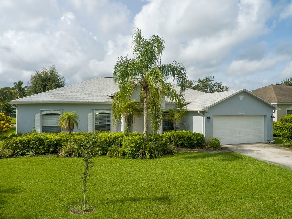 a front view of house with yard and green space