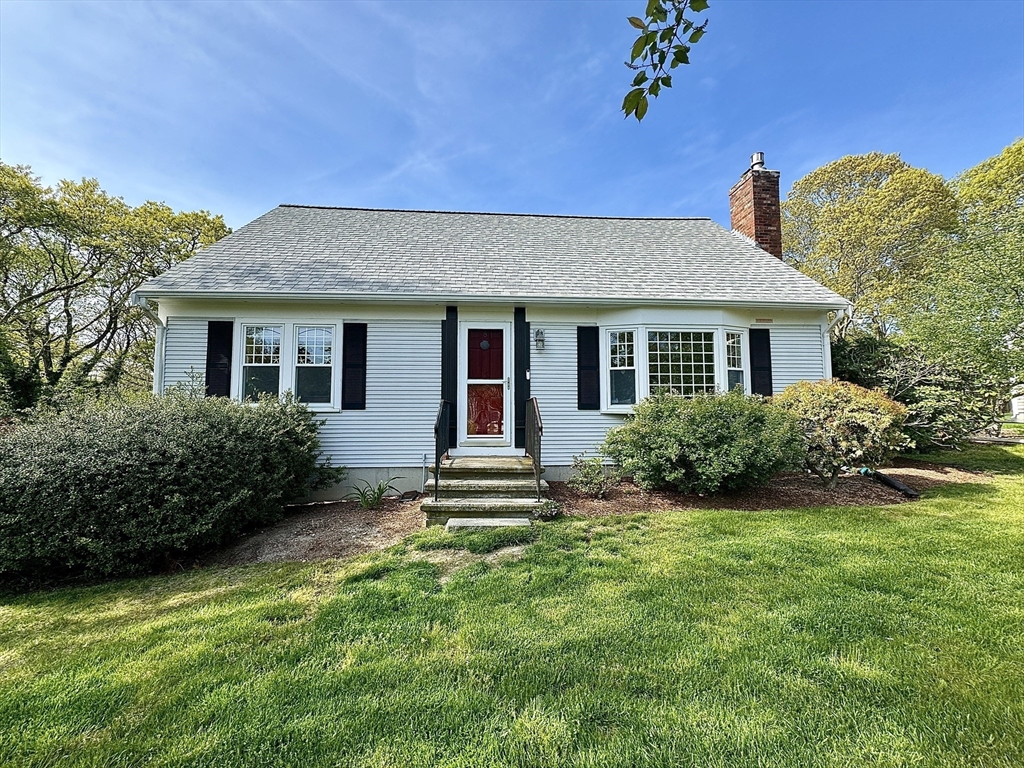 a front view of house with yard and green space