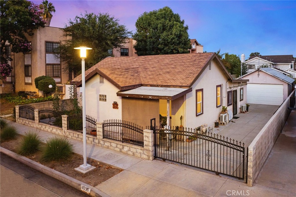 a view of a house with wooden fence