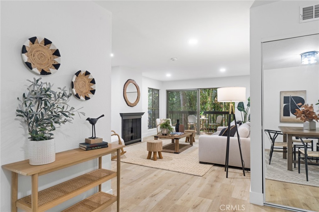 a living room with furniture potted plant and a large window