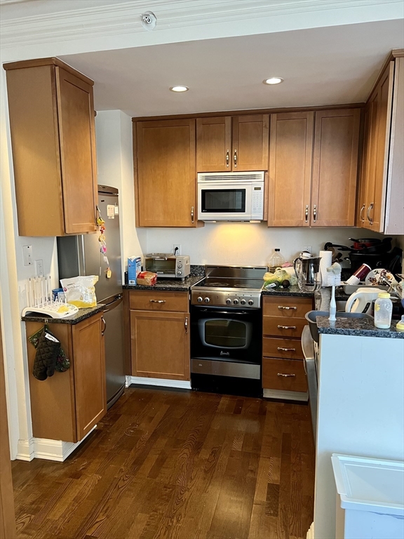 a kitchen with a stove a sink and a microwave