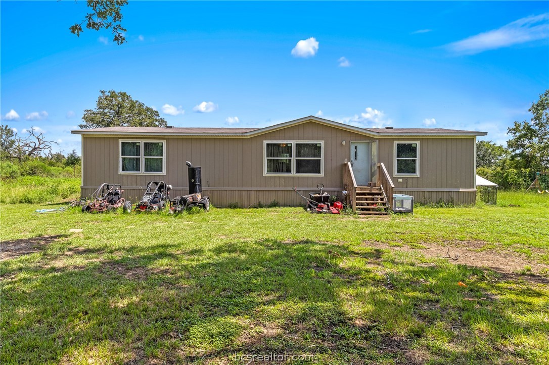 a front view of house with yard and outdoor seating