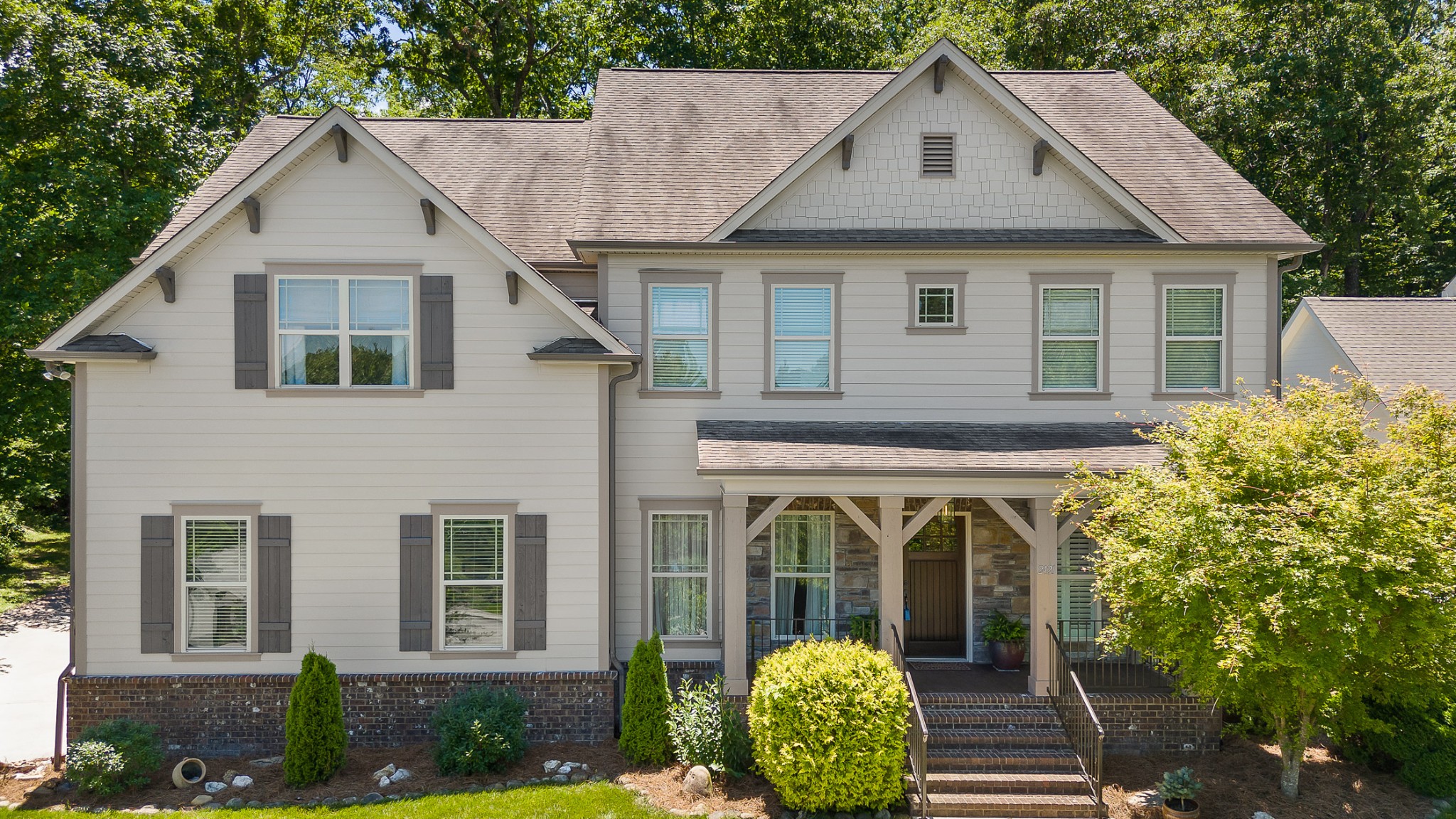 a front view of a house with garden