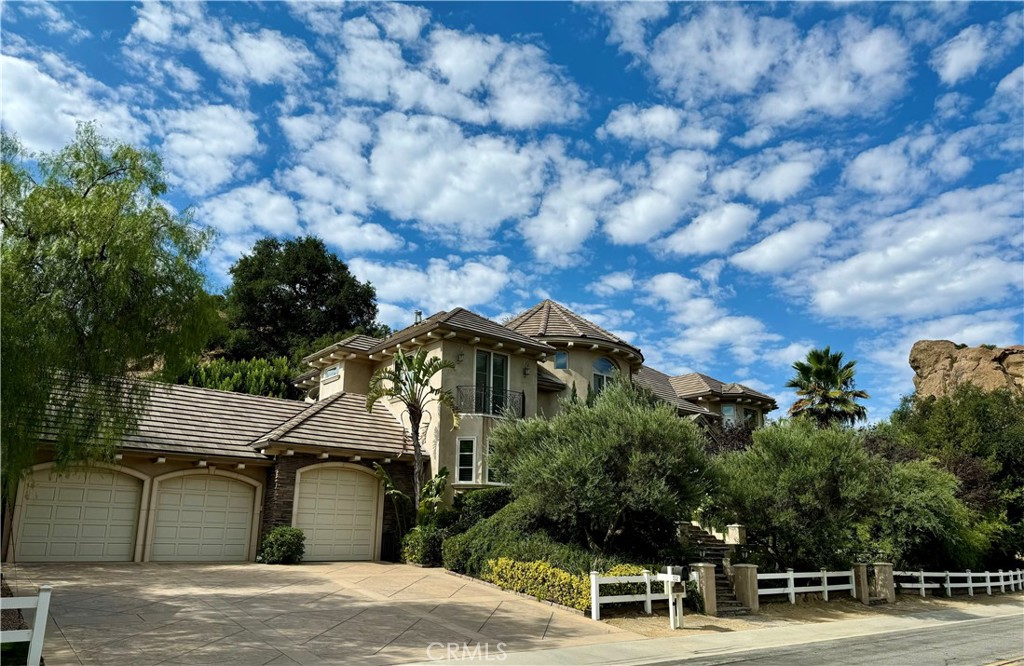 a view of a house with a yard and sitting area