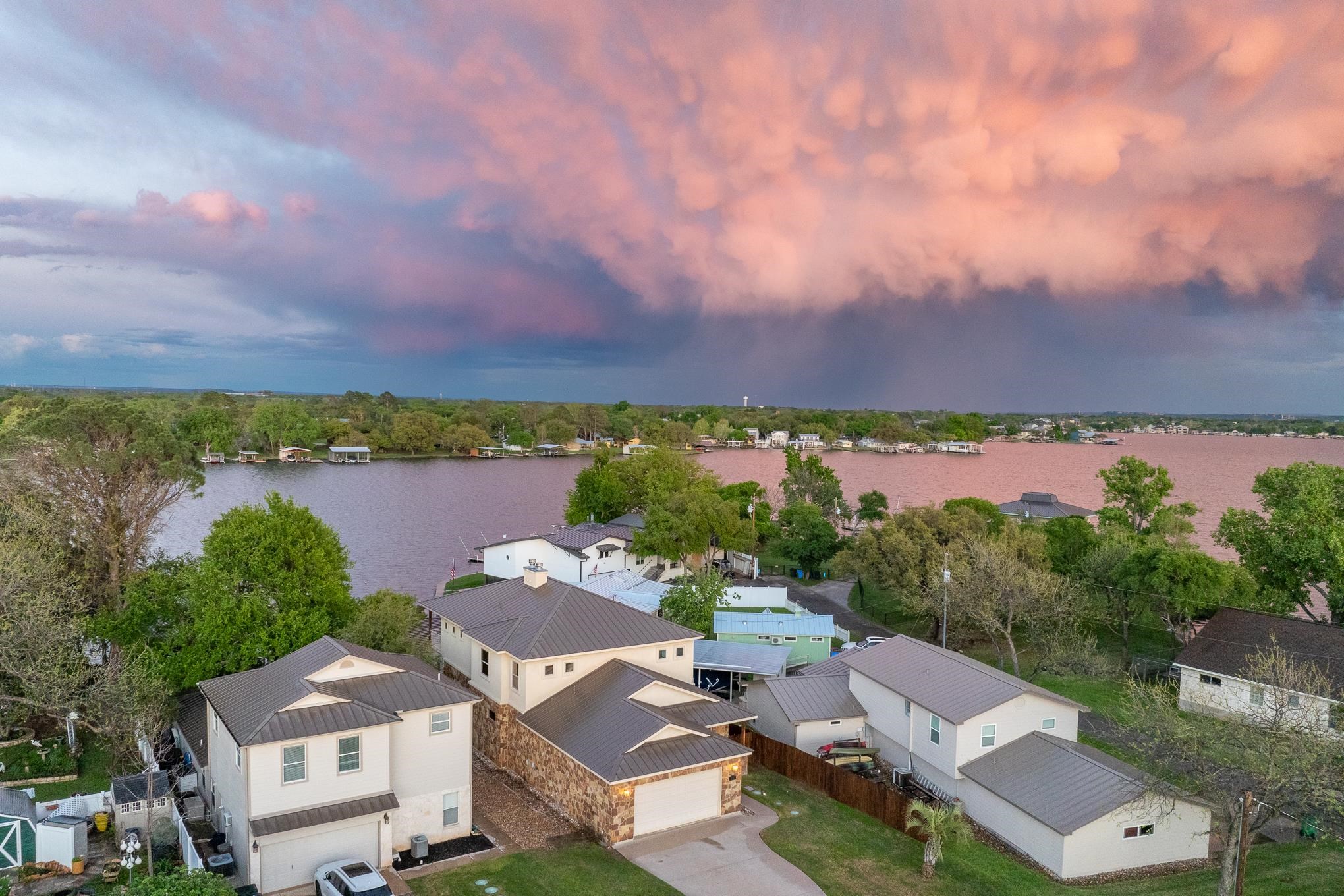 an aerial view of a house with a lake view