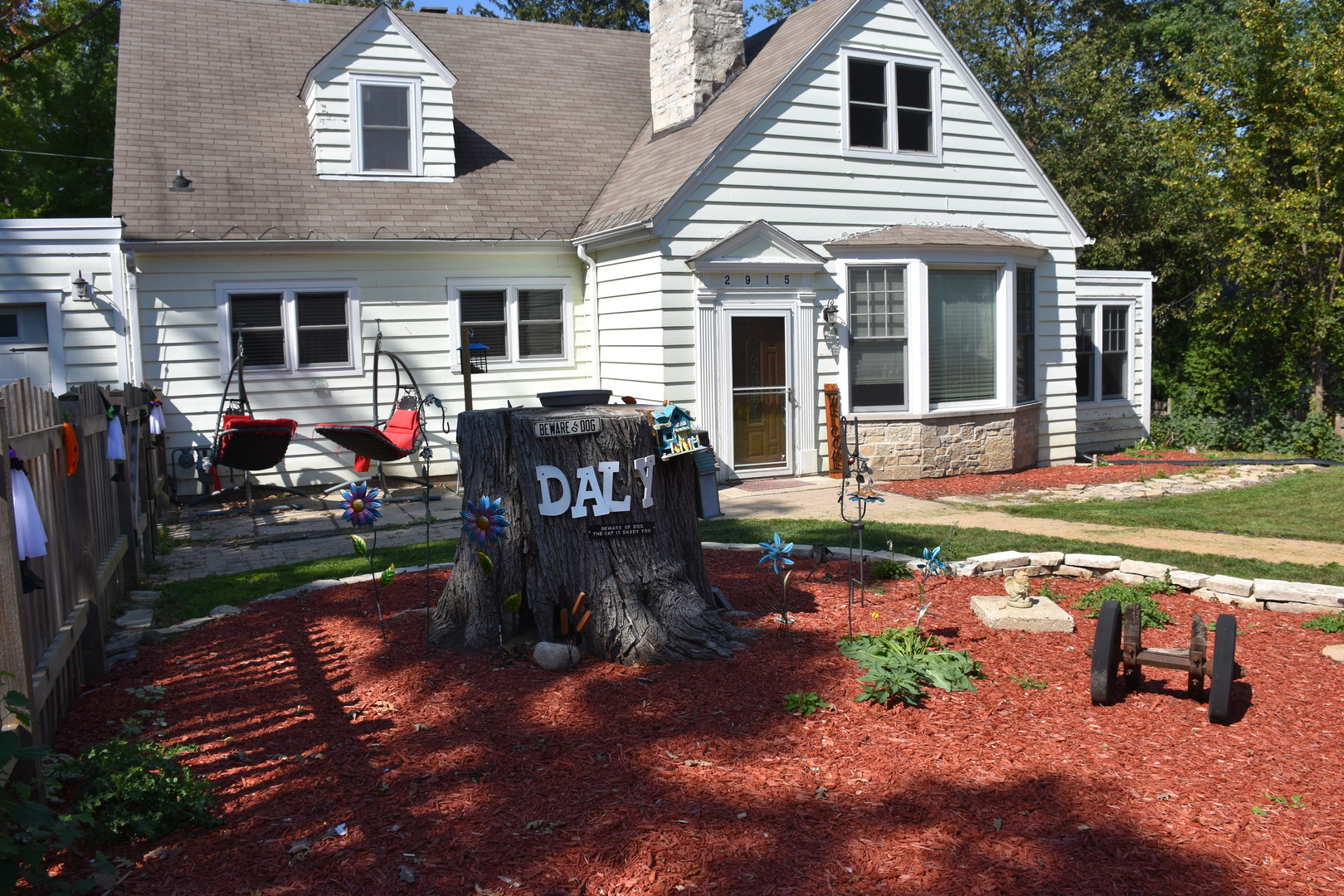 a view of a house with backyard and sitting area