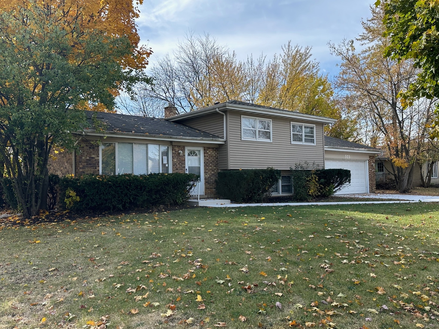 a front view of house with yard and trees