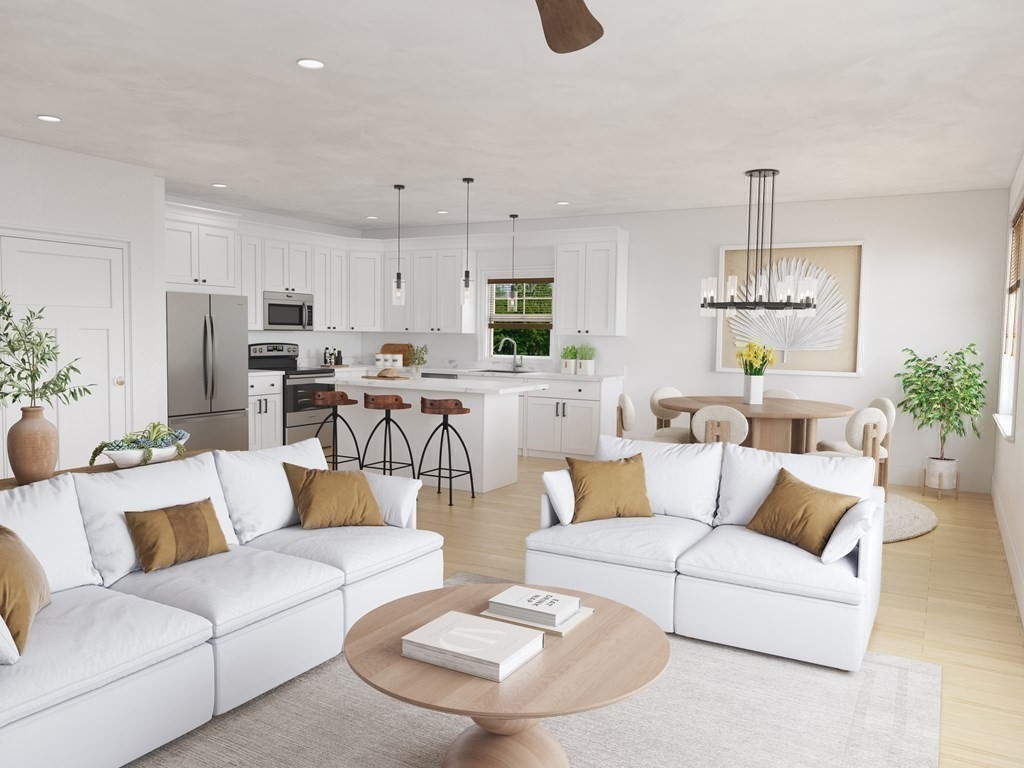 a living room with furniture and kitchen view