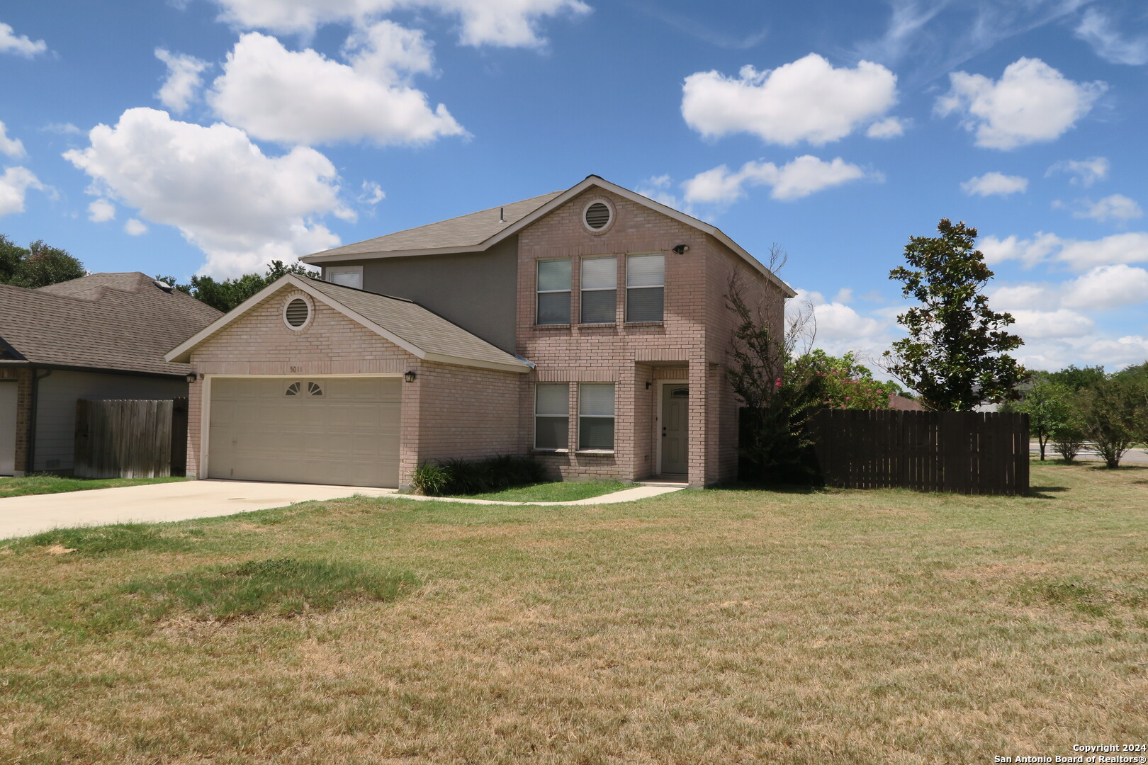 a view of a house with a yard and garage