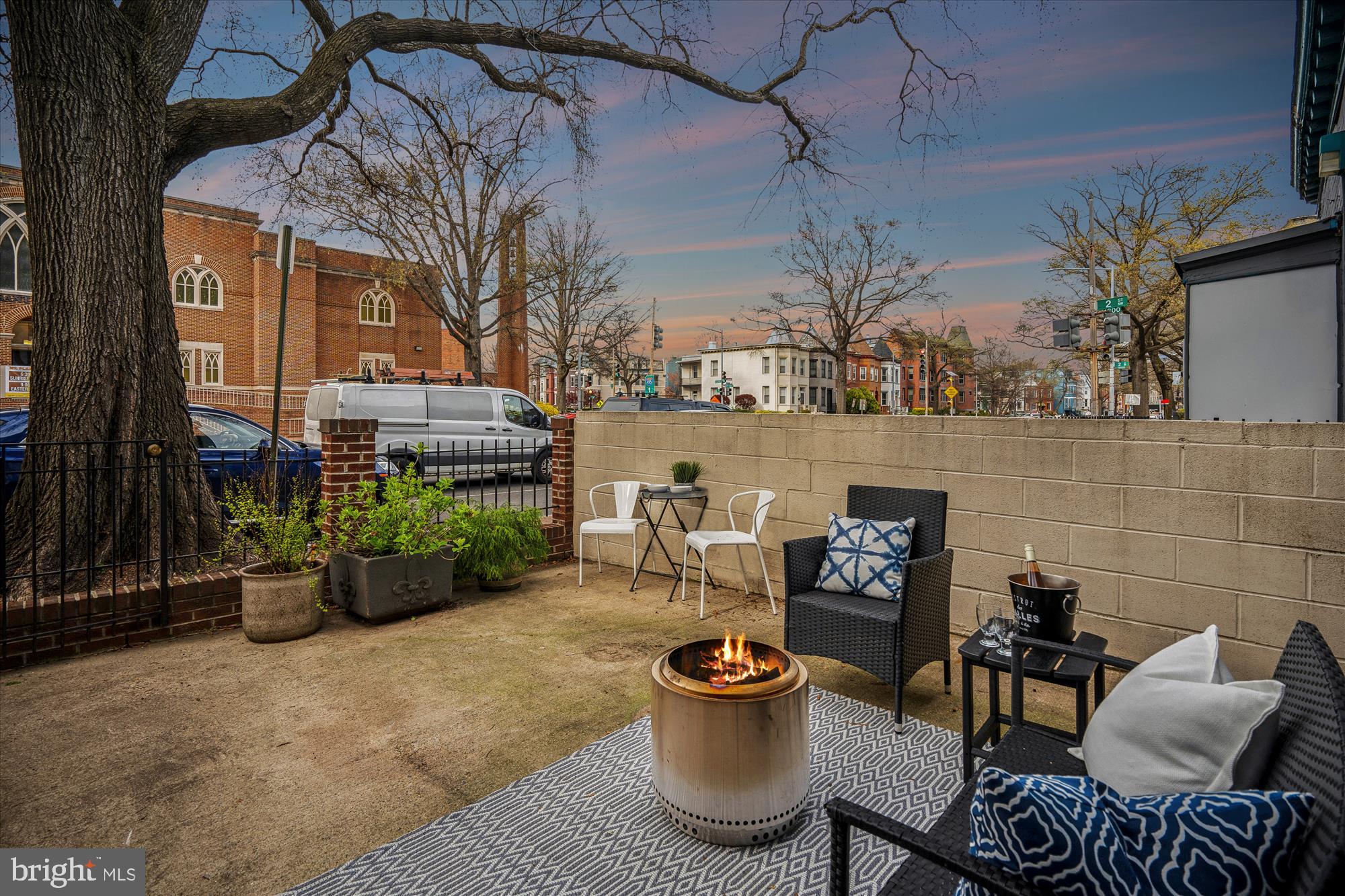 a view of a patio with couches chairs and a potted plant