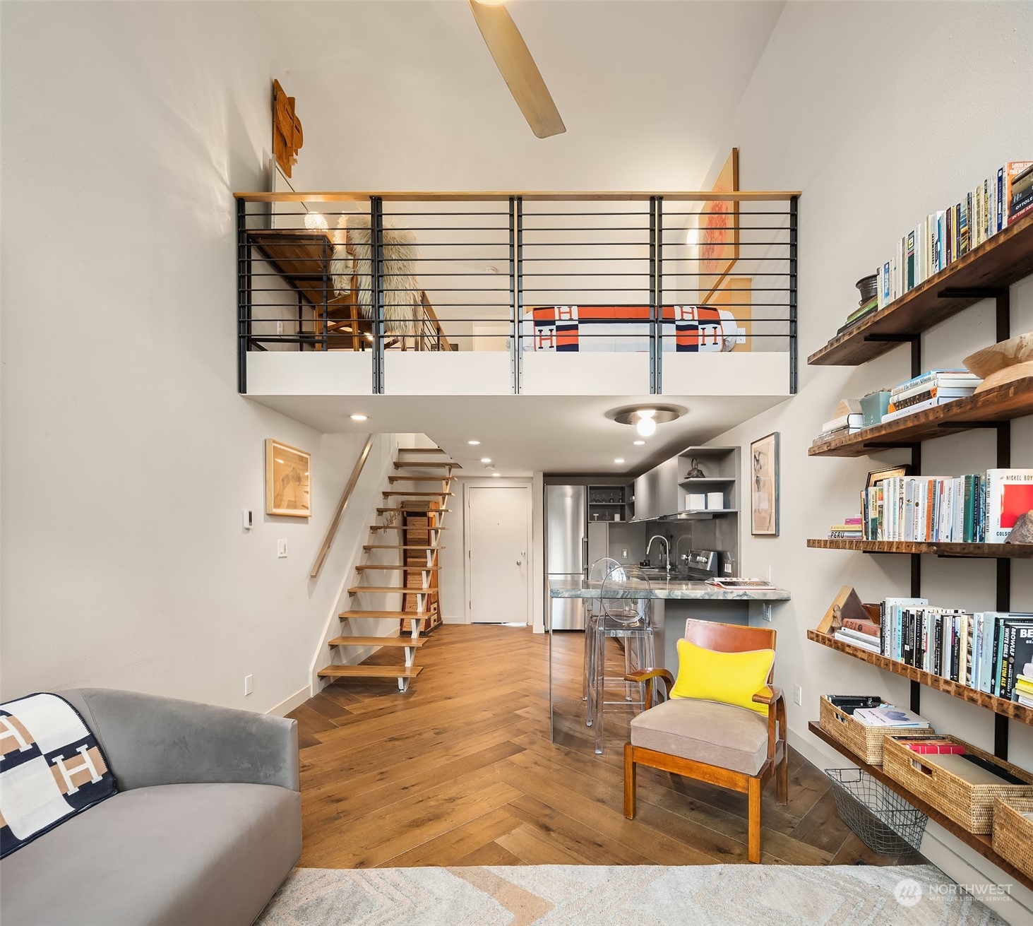 a living room with furniture and a book shelf