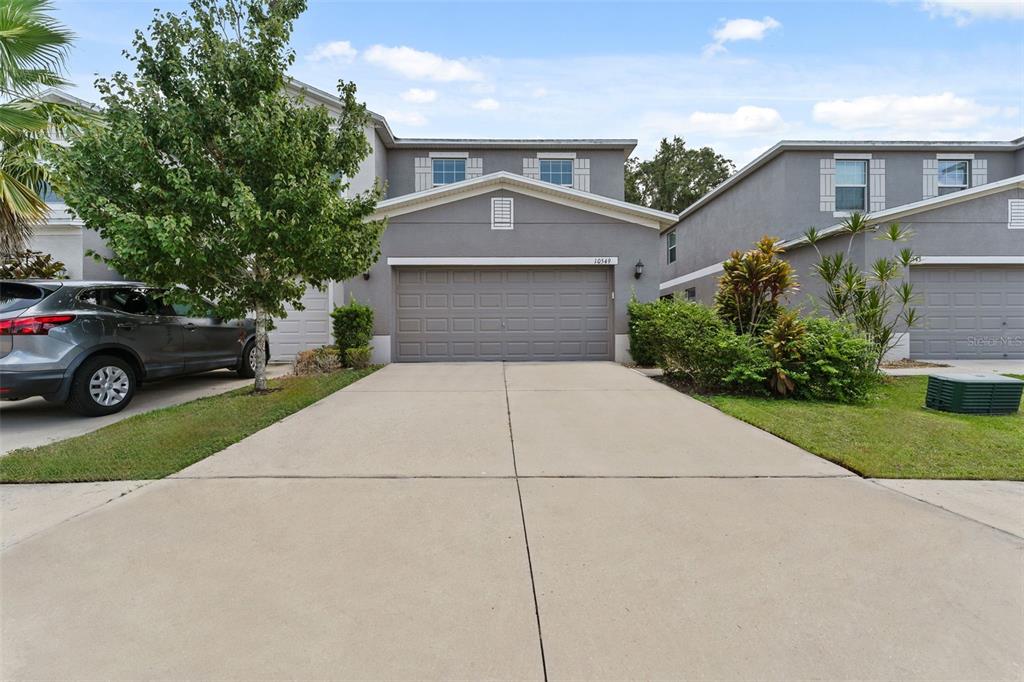 a front view of a house with a yard and garage