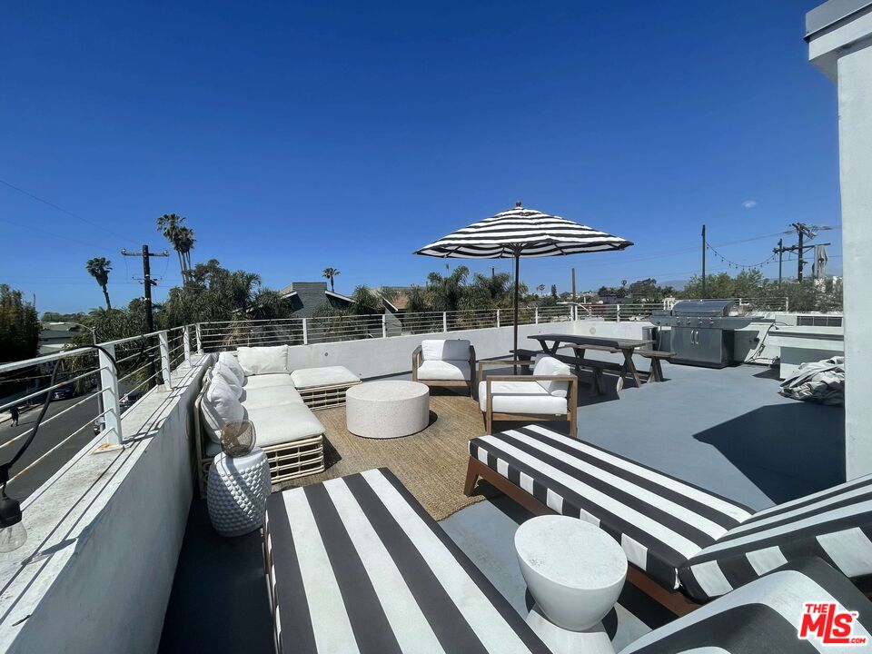 a view of a patio with chairs and a table