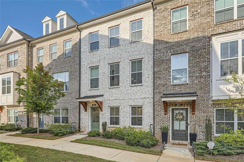 view of a brick building next to a yard