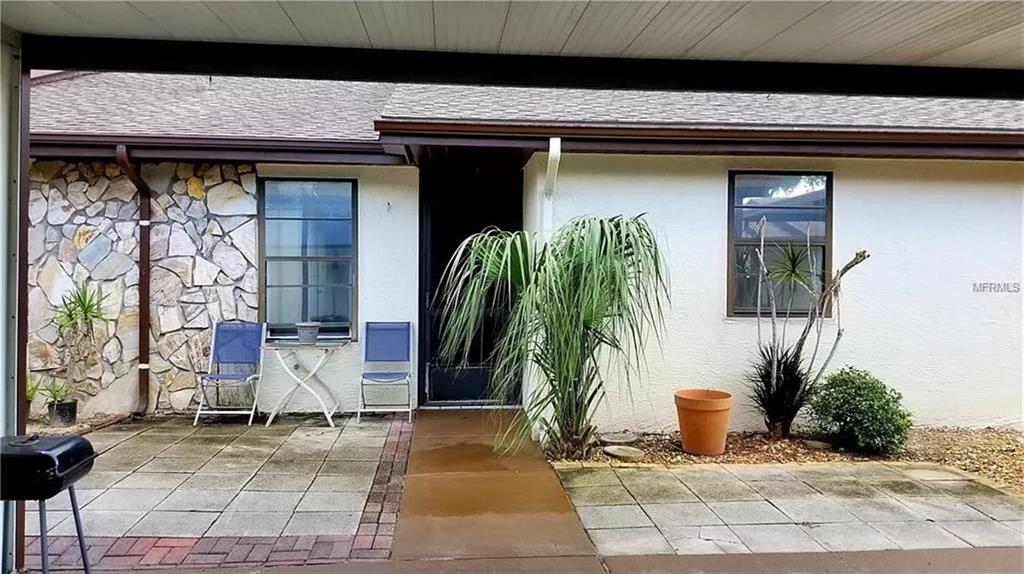 a potted plant sitting in front of a house