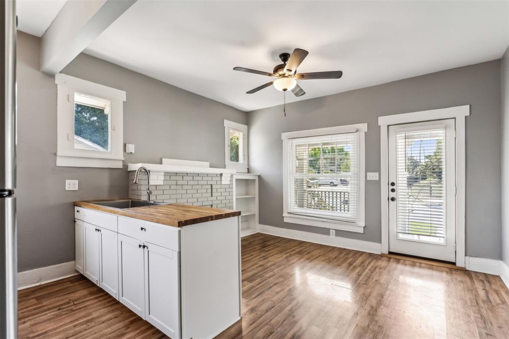 a kitchen with a stove a sink and a window