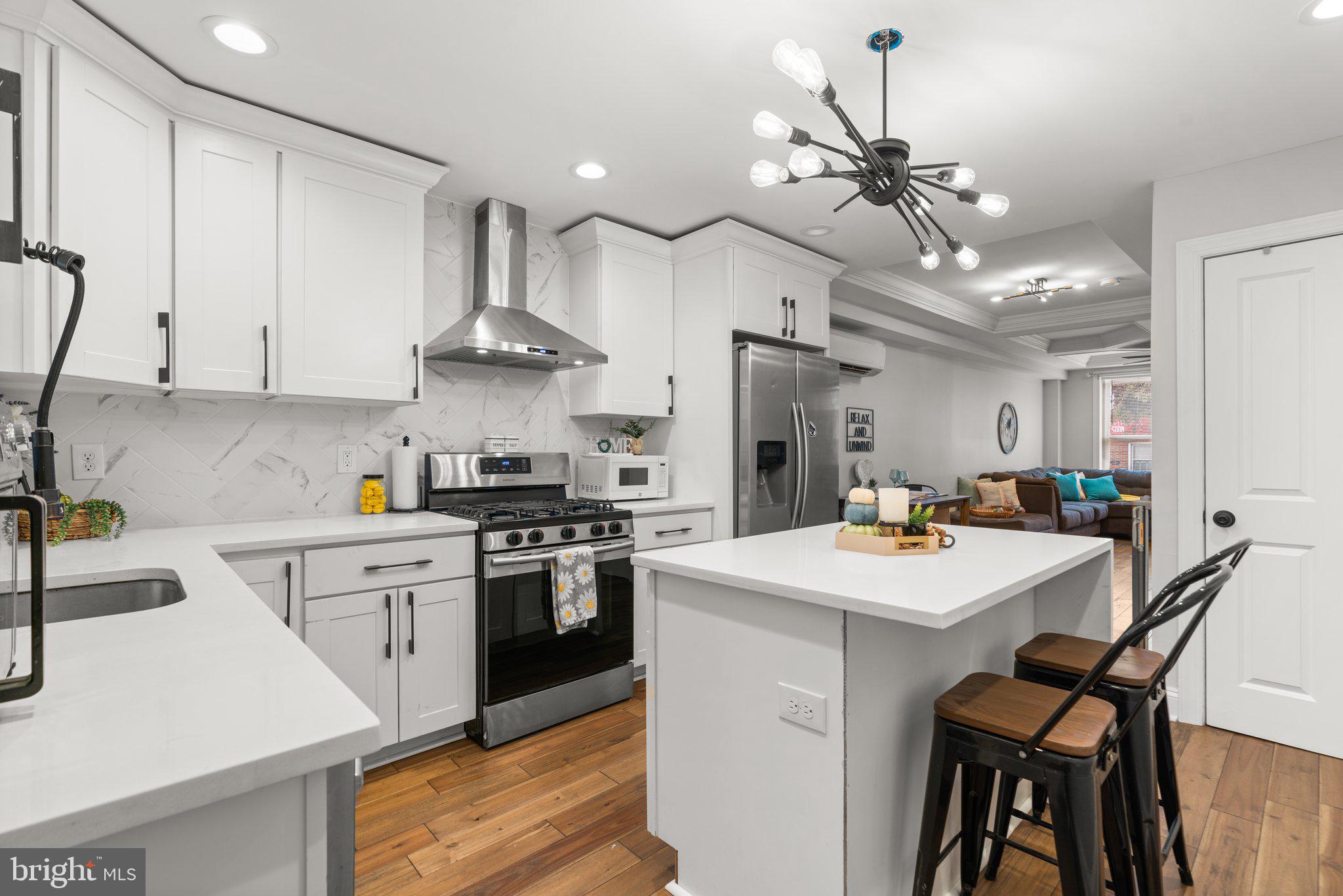 a kitchen with a stove a sink and a refrigerator