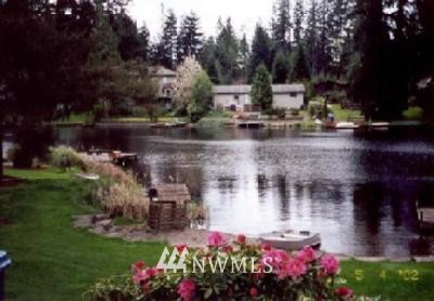 a view of yard with swimming pool and green space