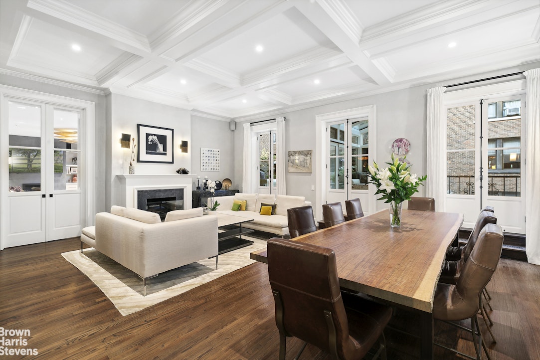 a living room with furniture a fireplace and a table