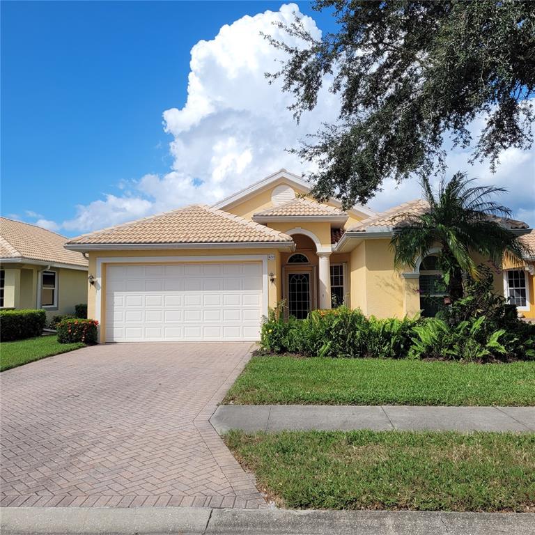 a front view of a house with a yard and garage