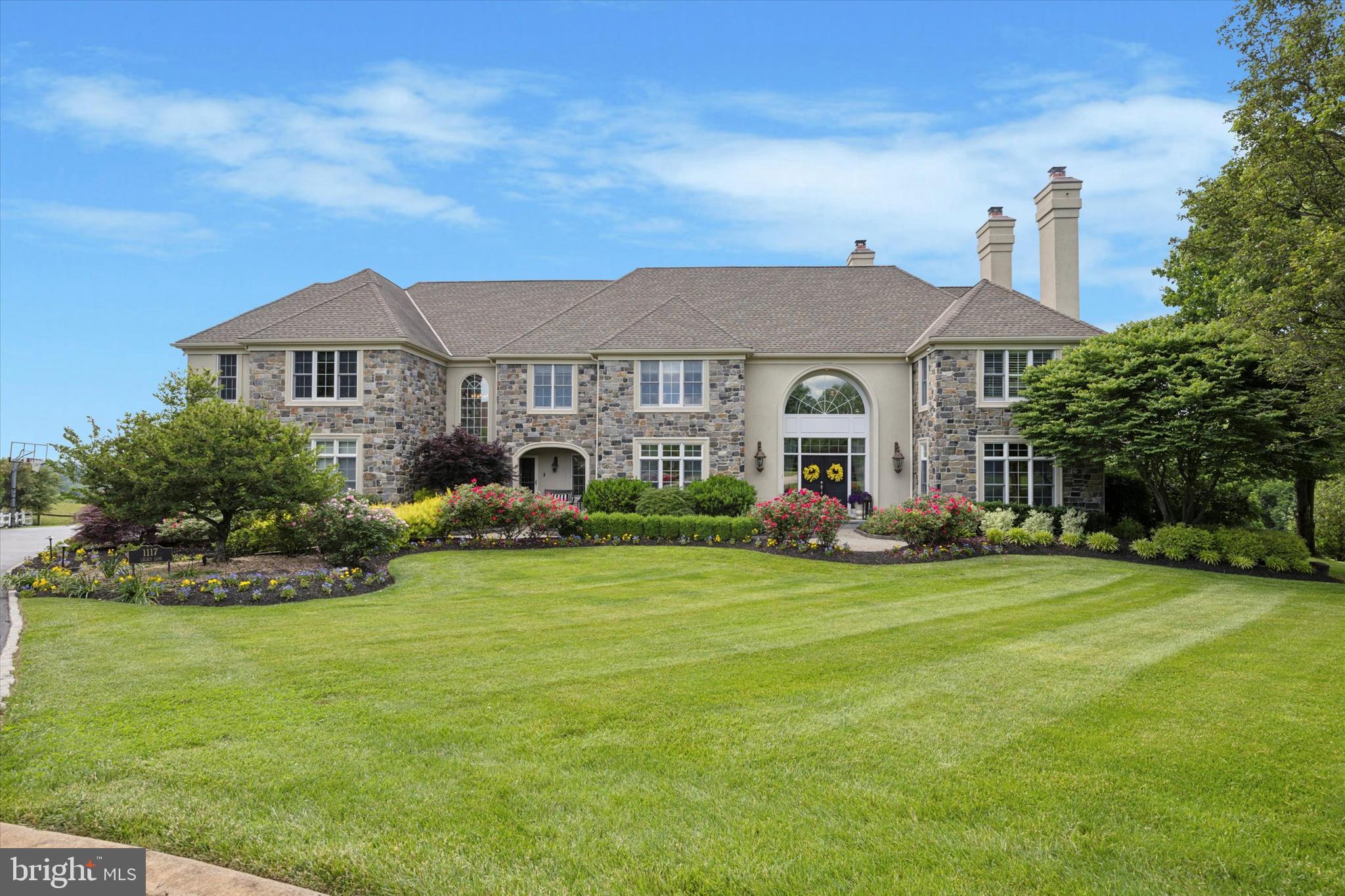 a front view of a house with a garden and plants