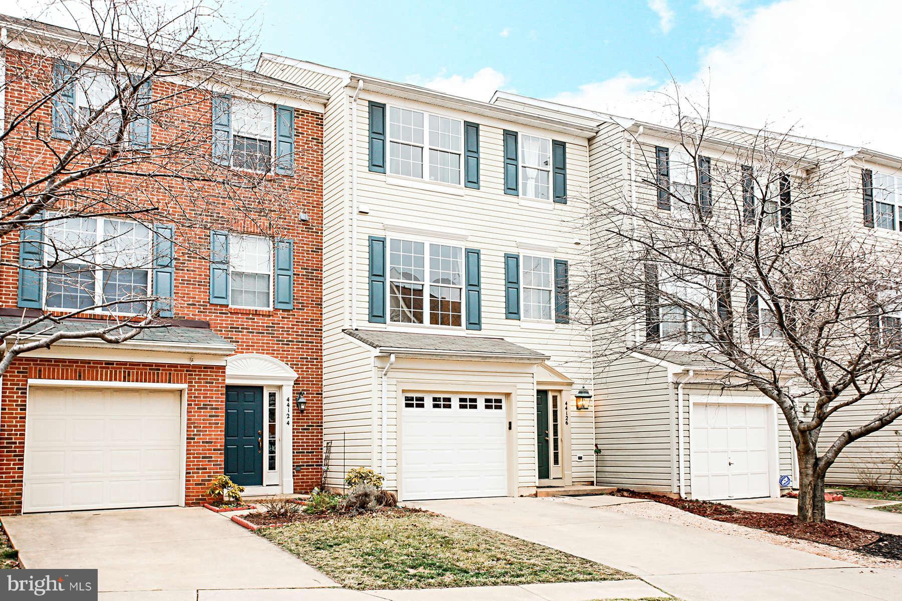 a front view of a residential houses with yard