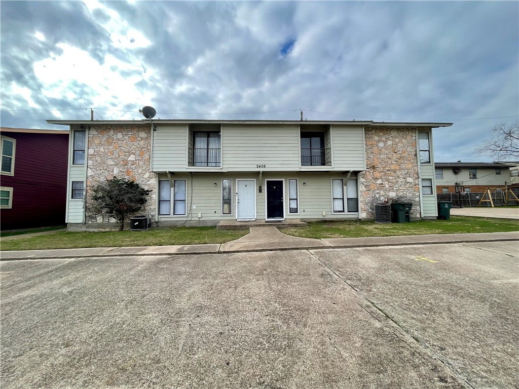 View of front of house featuring central AC