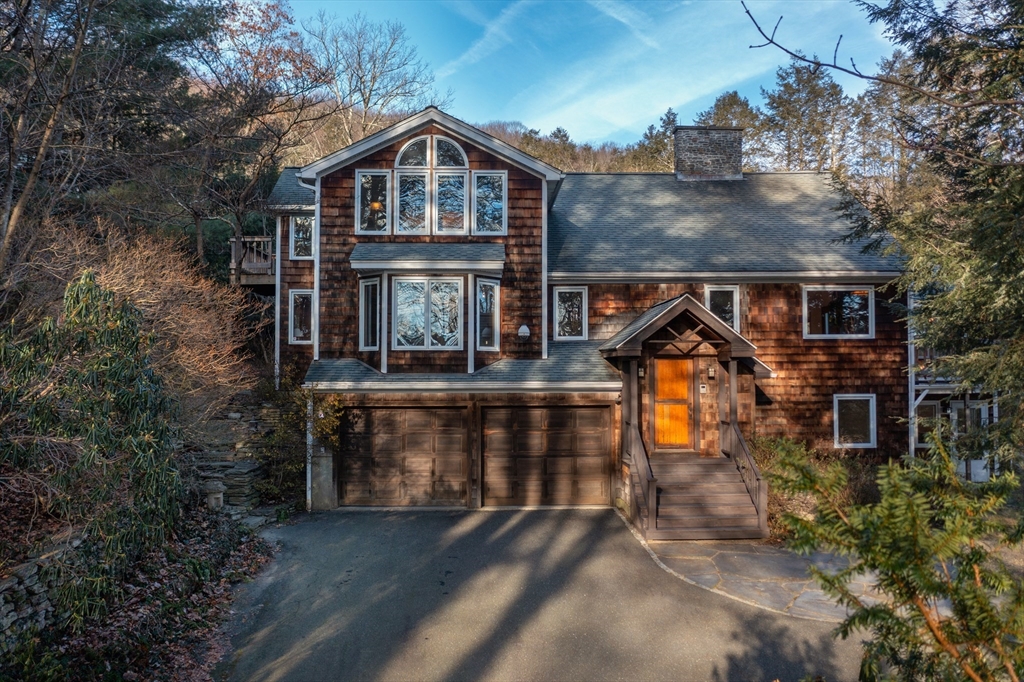 an aerial view of a house with roof deck front of house