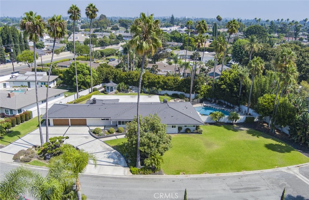 an aerial view of a house with swimming pool outdoor seating and yard