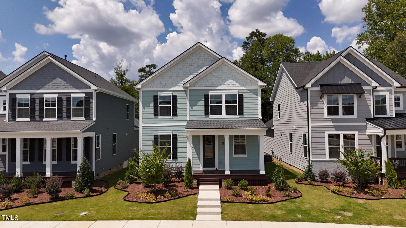 a front view of house and yard with green space