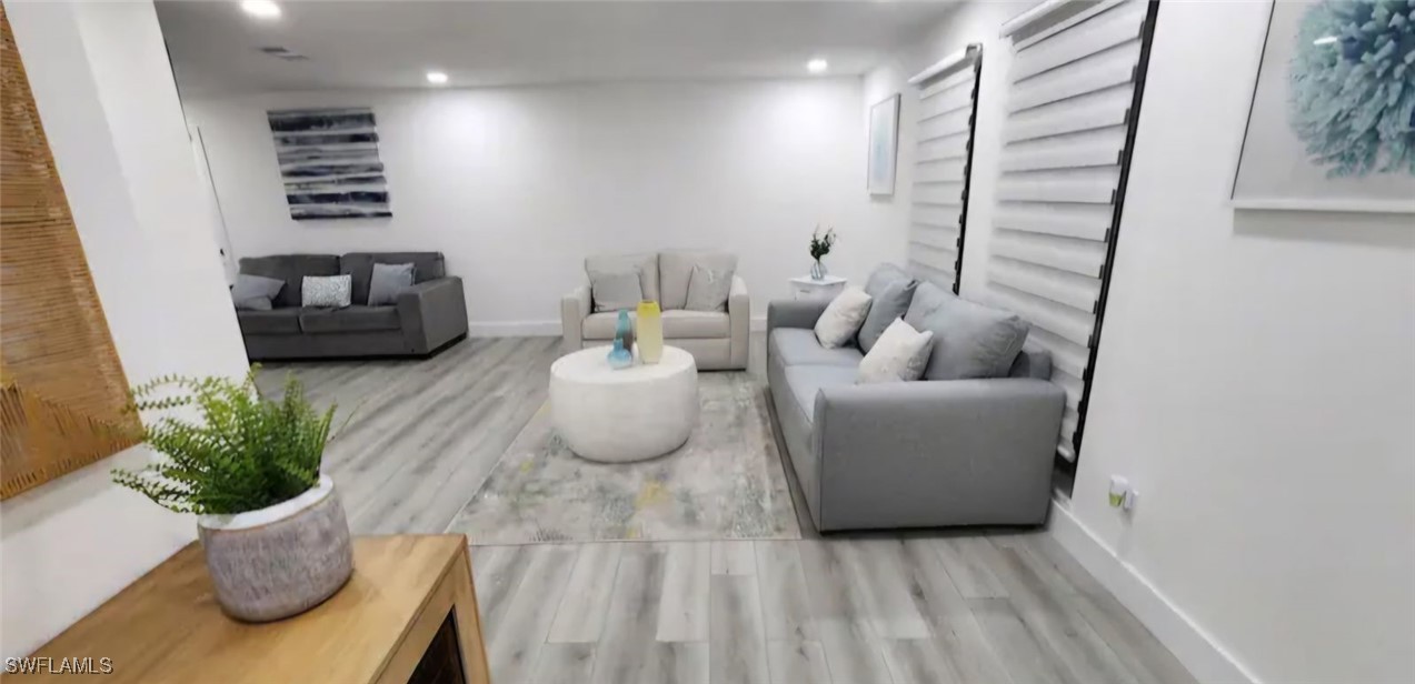 a living room with furniture and a potted plant