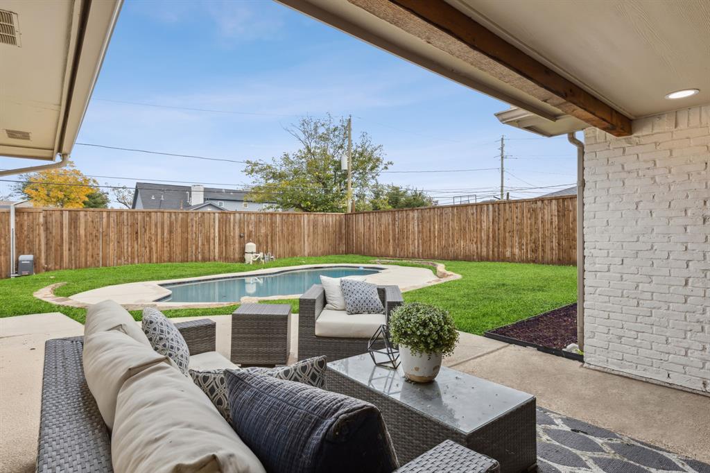 a view of a patio with couches chairs and a yard